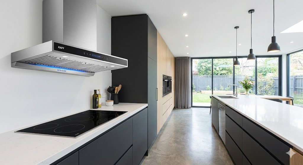 Kaff kitchen chimney with stainless steel body installed above gas hob